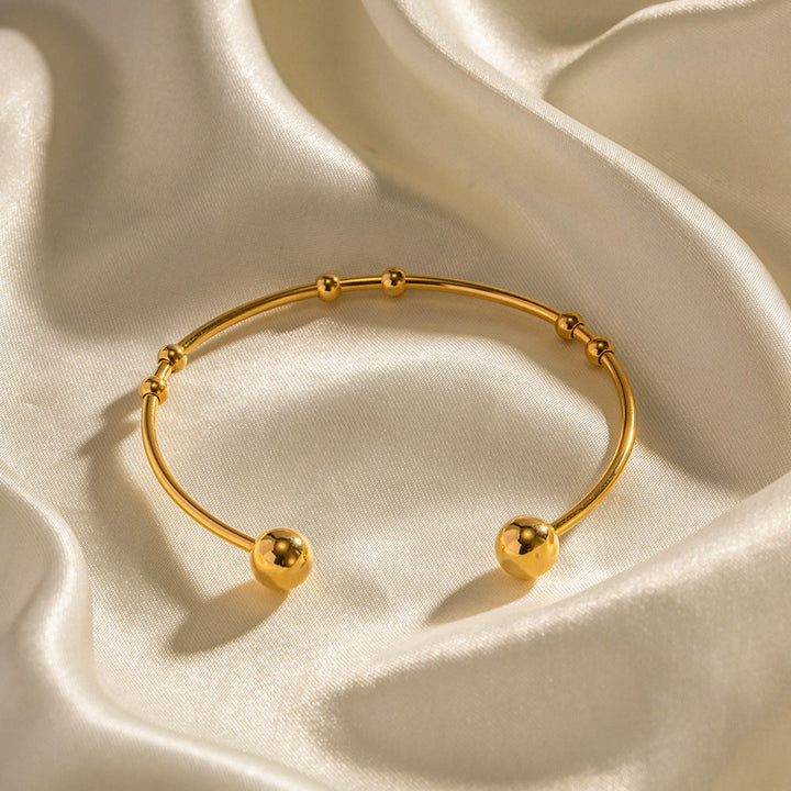 Valantomode | Plated Camille Bangle with Spherical Focal Assets and Monolithic Architecture