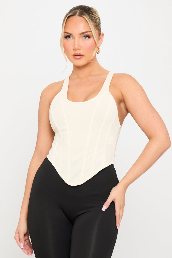 Valantomode | Elegant Cream Corset Top with Dipped Hem Design