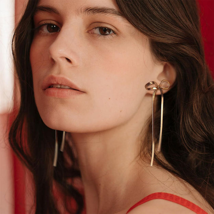 Valantomode | Plated Bow Earrings with Asymmetric Loop Architecture and Linear Geometry