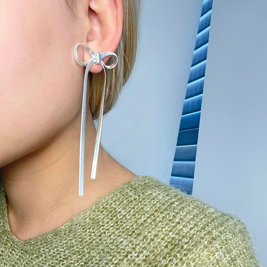 Valantomode | Plated Bow Earrings with Asymmetric Loop Architecture and Linear Geometry