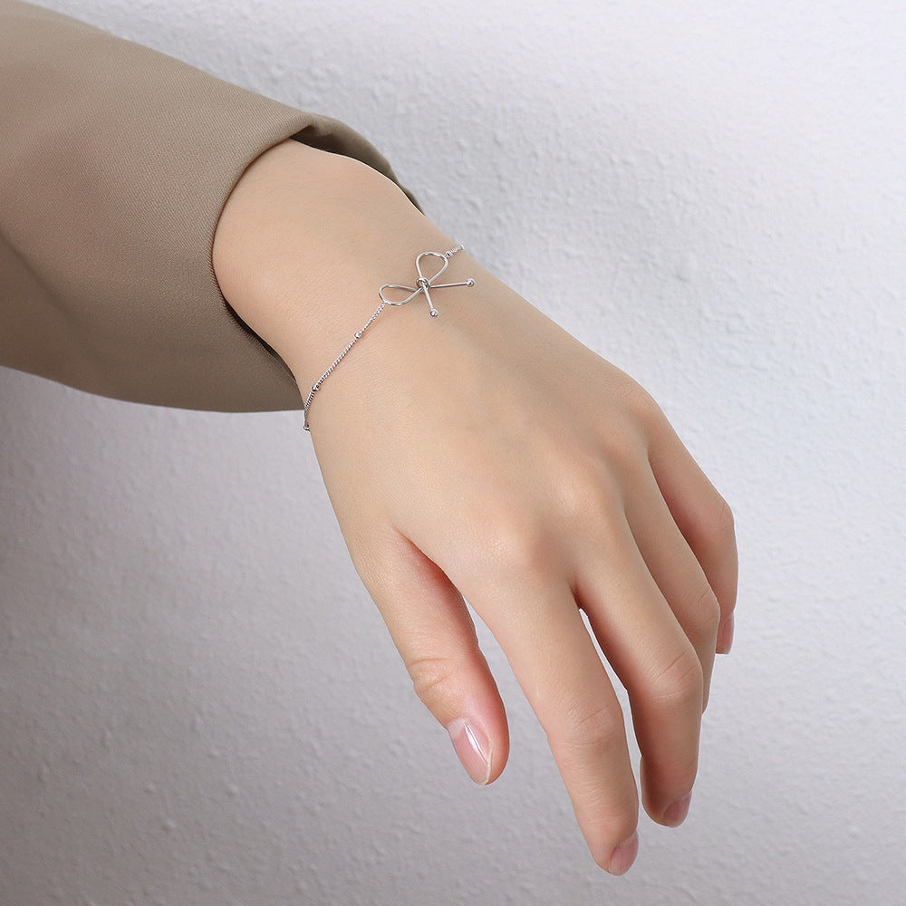 Valantomode | Plated Symmetrical Bow Bracelet with Linear Ribbon Structuralism