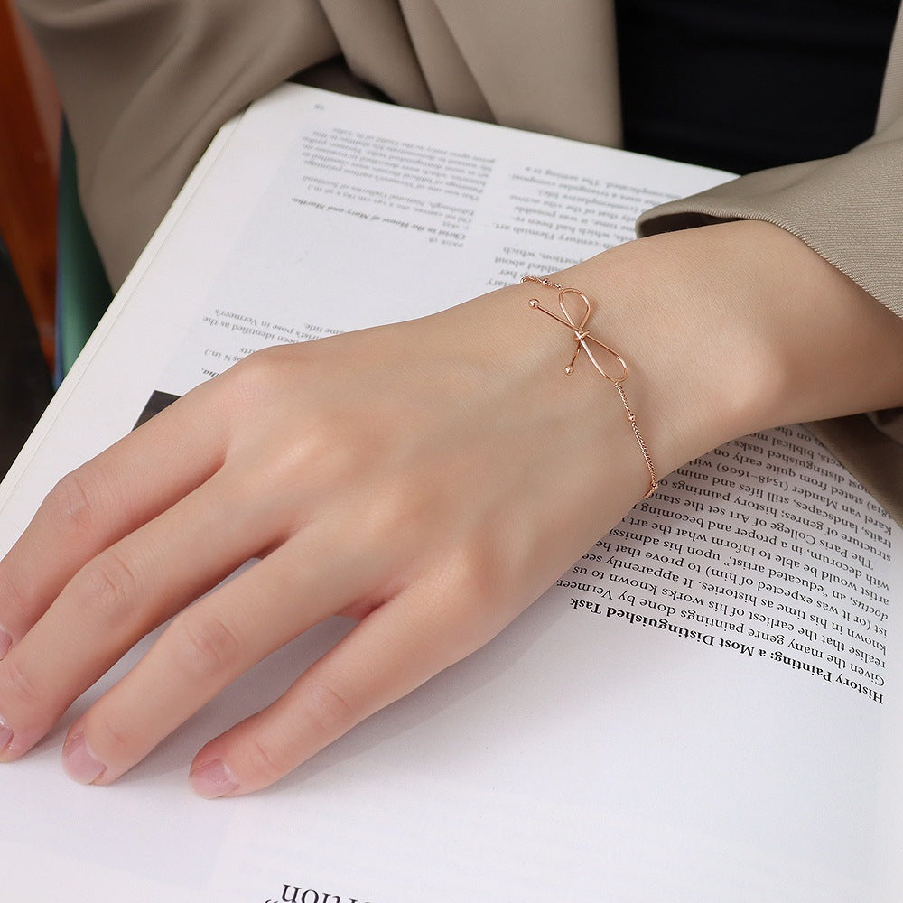 Valantomode | Plated Symmetrical Bow Bracelet with Linear Ribbon Structuralism