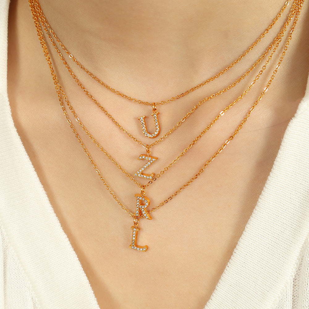 Valantomode | Plated Stainless Steel Typographic Necklace with Refractive Stone Asset